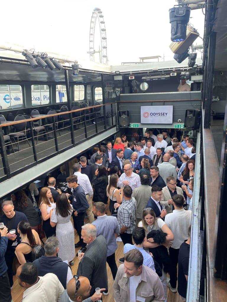 Guests filling the deck of the boat, with the London Eye behind