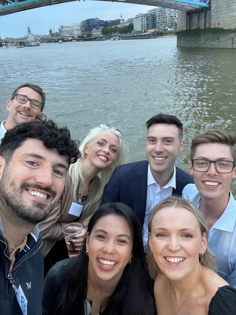 A group of guests on deck by the river